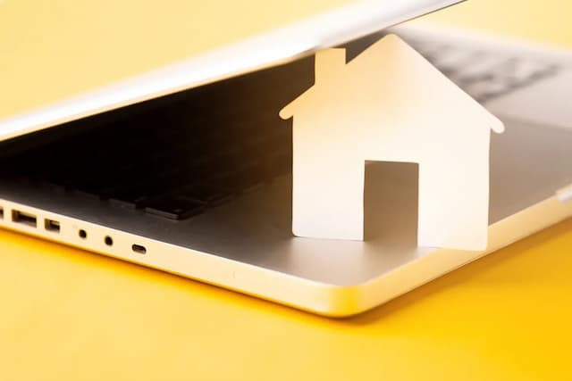 House cutout in between closing laptop